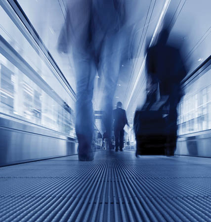 Businesspeople rushing on the airport walkway  Unrecognizable people walking by  Air Travel Concept Shot 